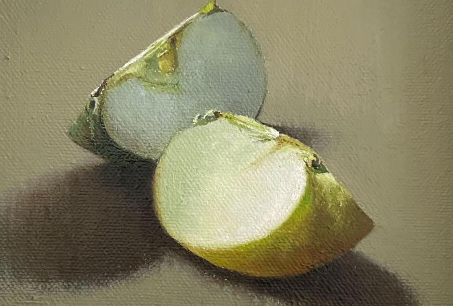 a small painting of two quarters of an apple