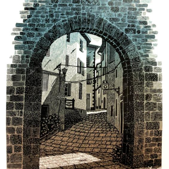 a lino print of an archway looking to houses
