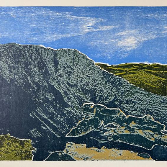 a coloured print of a rocky landscape with a blue sky